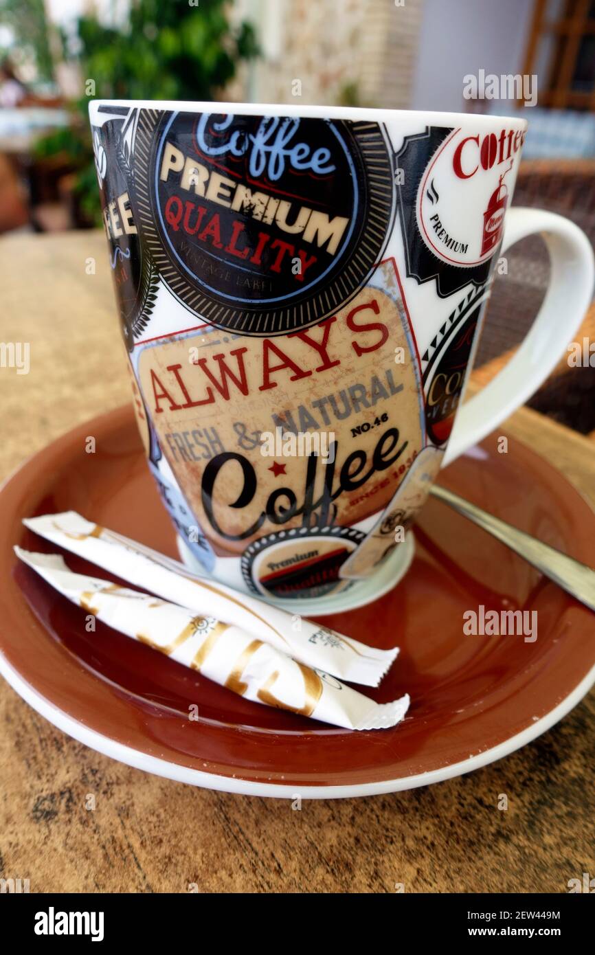 Coffee cup and saucer with sugar on the side in a cafe Stock Photo
