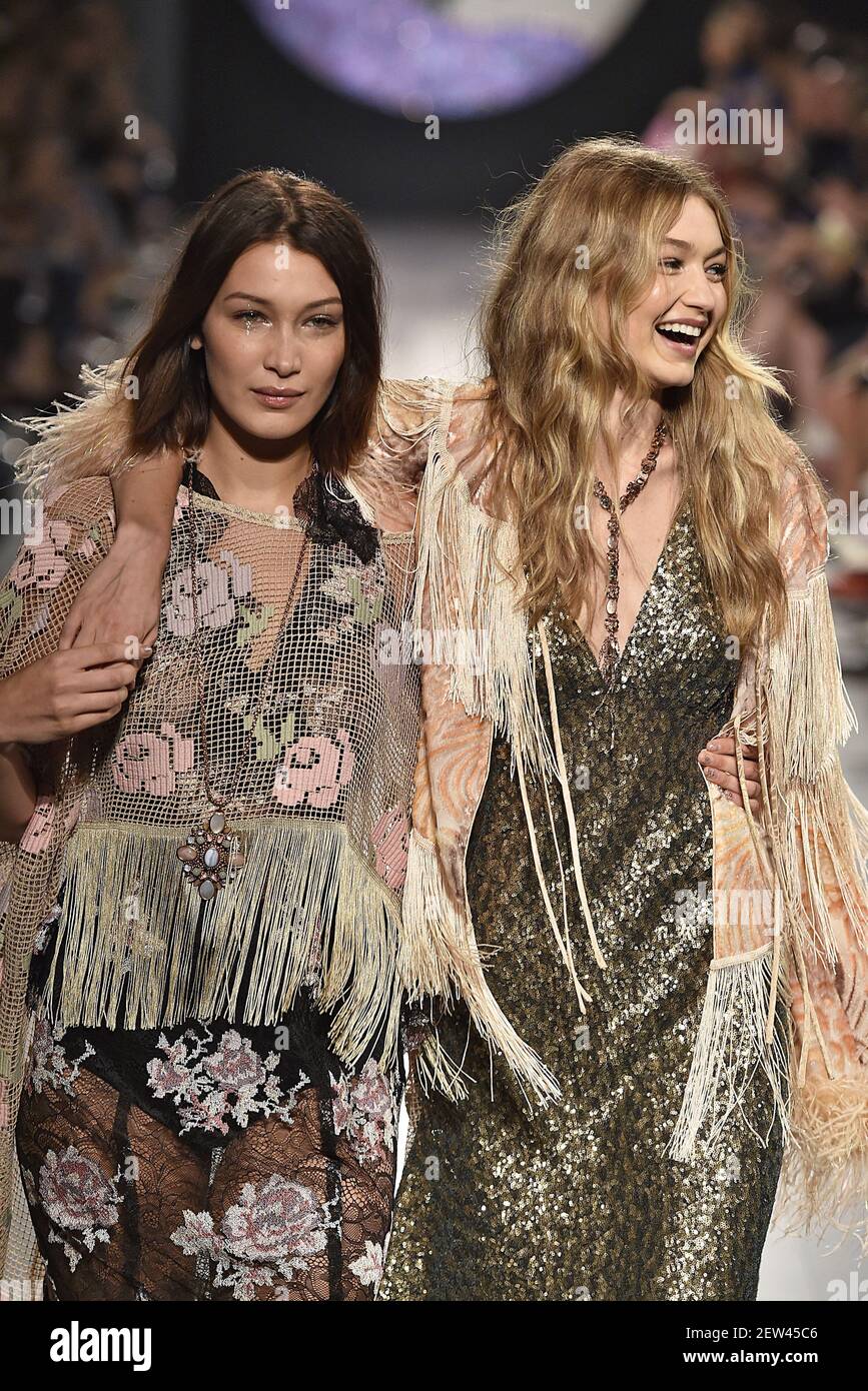 Bella Hadid and Gigi Hadid walk on the runway during the Anna Sui