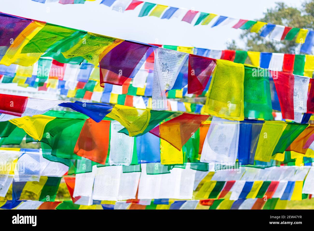 Colorful Prayer Flags. Tibetan Prayer flags with Buddhist scripts. Stock Photo