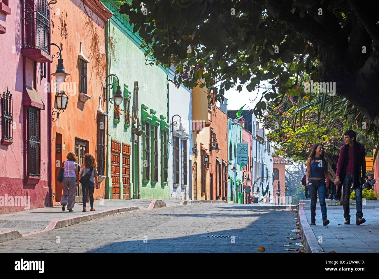 Street with pastel coloured colonial houses and hotels in the city Cuernavaca, state of Morelos, Mexico Stock Photo