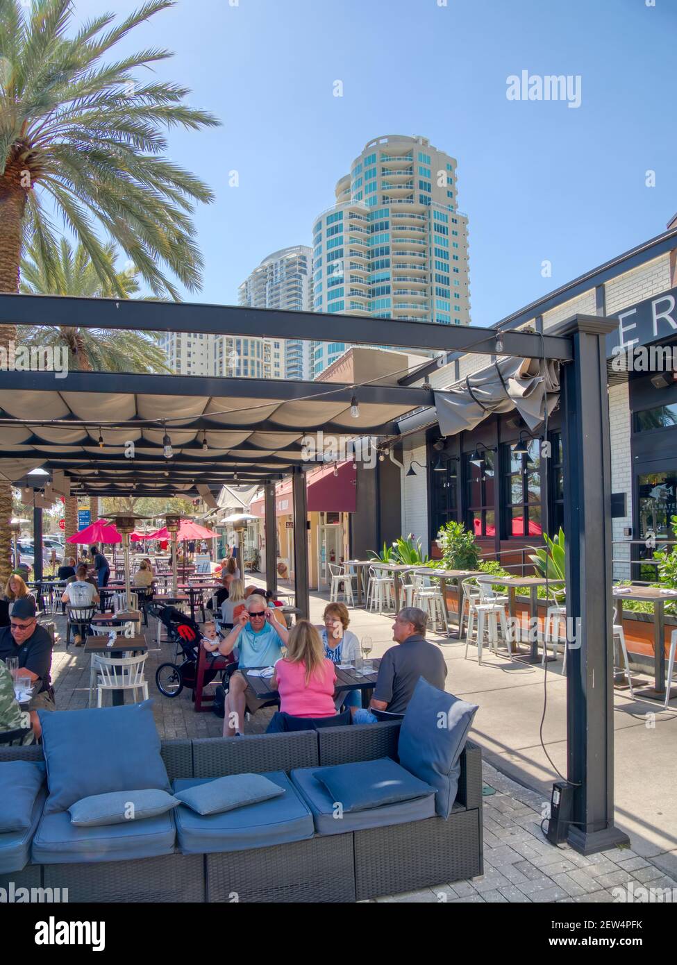 People eating at an outdoor cafe on the sidewalk on Beach Drive NE in
