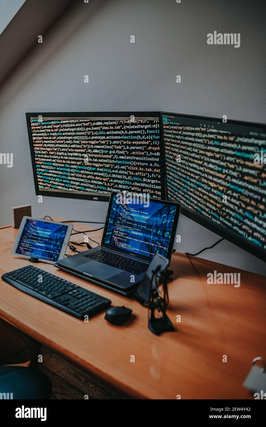 A vertical shot of programmer's desk with types of electronic equipment ...