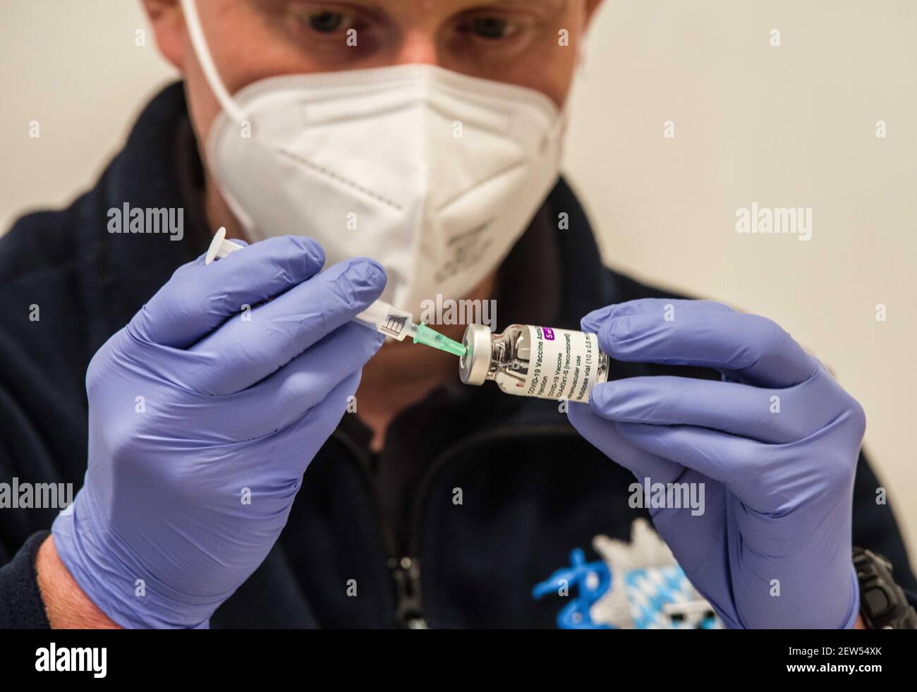 Munich, Bavaria, Germany. 2nd Mar, 2021. A medical services technician with the Munich Bereitschaftspolizei prepares the next round of vaccines by extracting a small volume from a vial. Each vial is good for ten vaccinations. Starting with some 10,000 doses of the AstraZeneca Covid-19 vaccine, the Bavarian Police has begun vaccinating its Bereitschaftspolizei and Einsatzeinheiten- specialized police units that deal with demonstrations, riots, and other missions. Germany's vaccine program has been criticized for being extremely slow, with numerous nations surpassing not only percentage of Stock Photo
