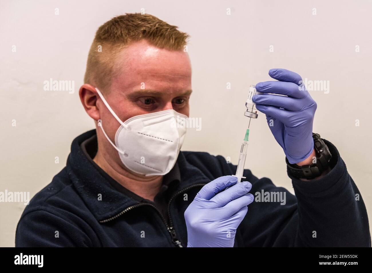 Munich, Bavaria, Germany. 2nd Mar, 2021. A medical services technician with the Munich Bereitschaftspolizei prepares the next round of vaccines by extracting a small volume from a vial. Each vial is good for ten vaccinations. Starting with some 10,000 doses of the AstraZeneca Covid-19 vaccine, the Bavarian Police has begun vaccinating its Bereitschaftspolizei and Einsatzeinheiten- specialized police units that deal with demonstrations, riots, and other missions. Germany's vaccine program has been criticized for being extremely slow, with numerous nations surpassing not only percentage of Stock Photo