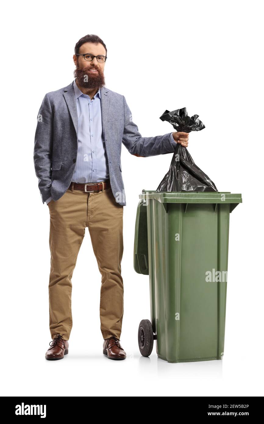Full length portrait of a bearded man throwing a bin bag in a dustbin isolated on white background Stock Photo
