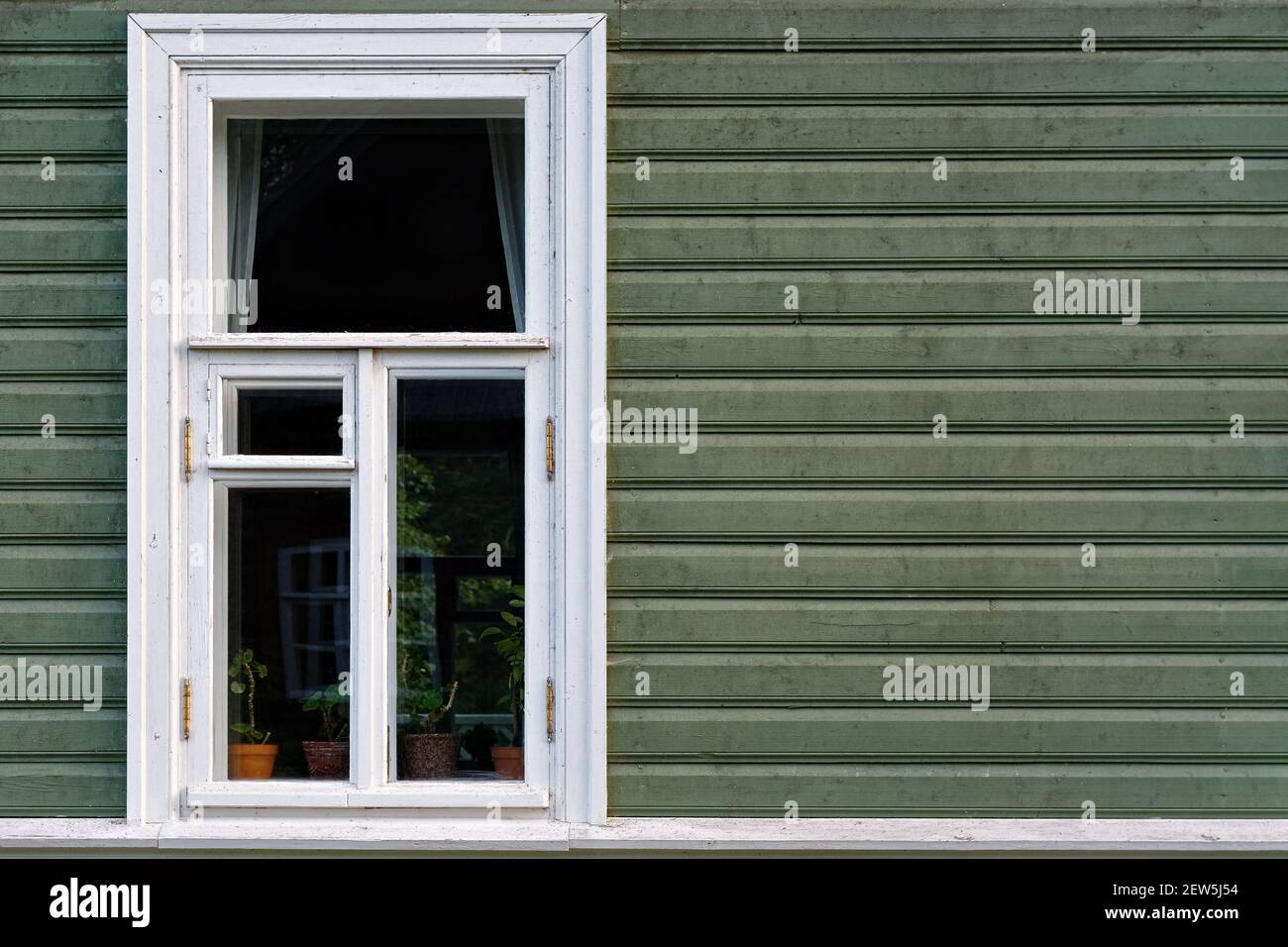 Rectangular window with a white frame on the background of a wall made ...