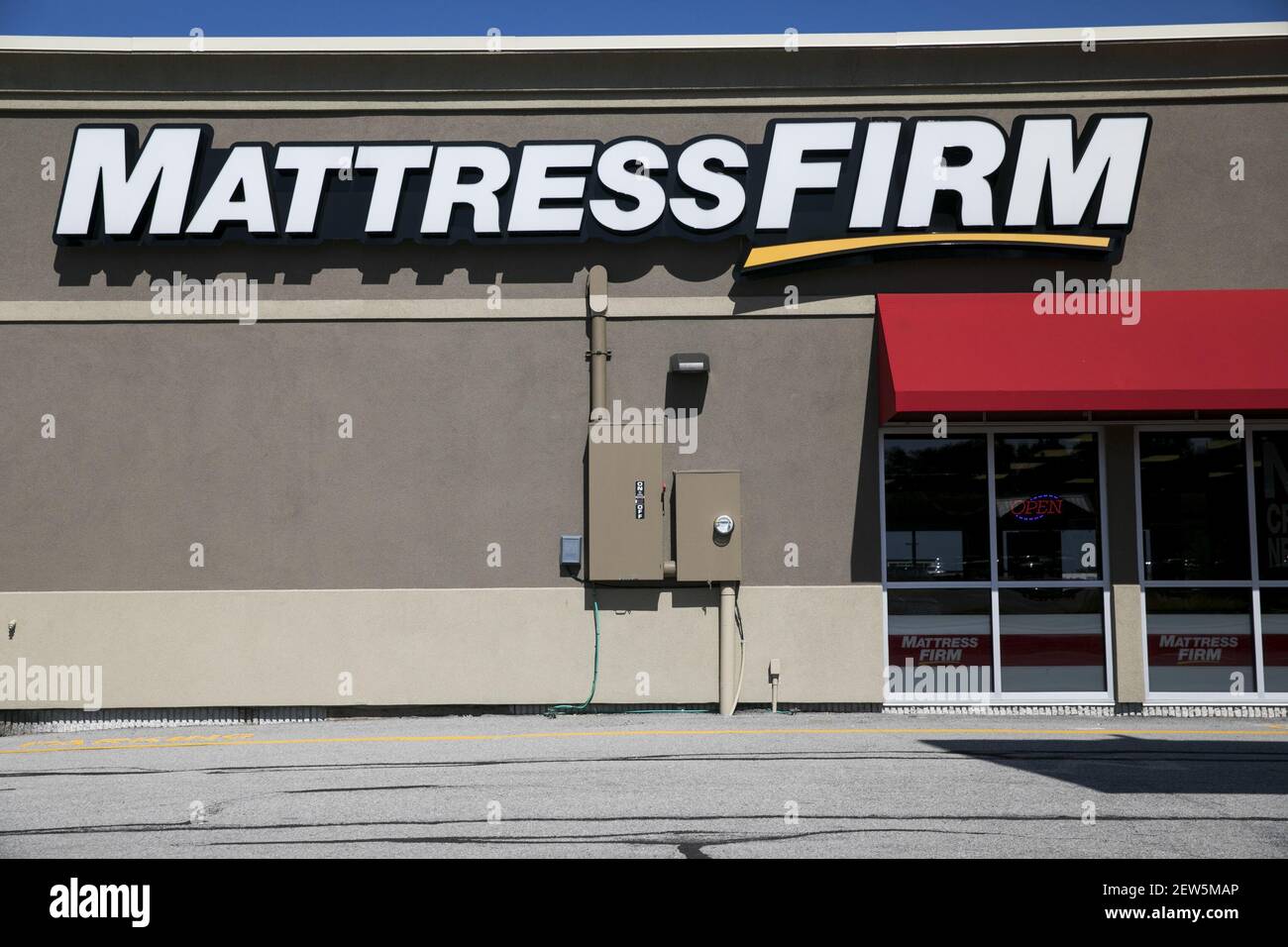 A logo sign outside of a Mattress Firm retail store in Altoona
