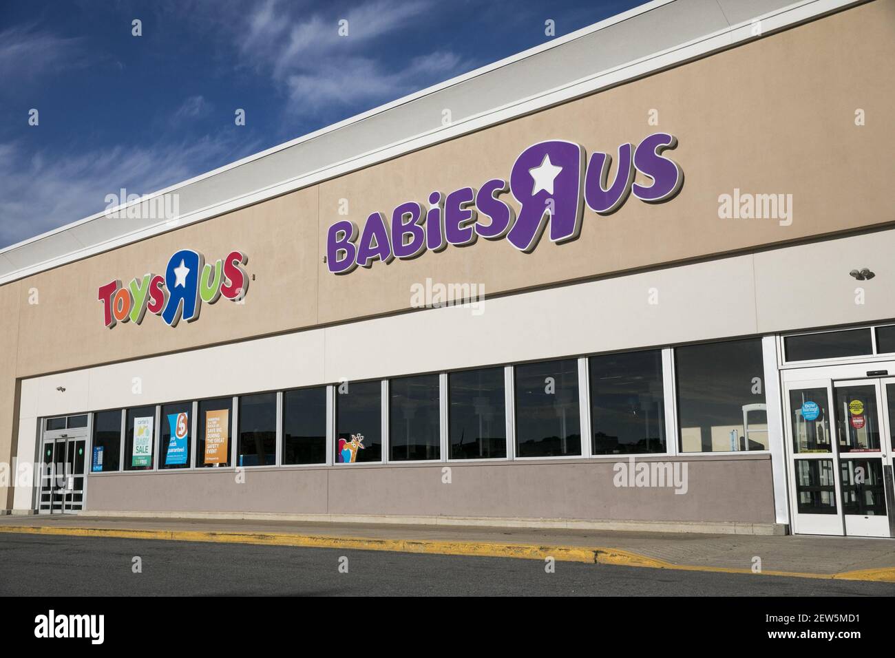 A logo sign outside of a Toys