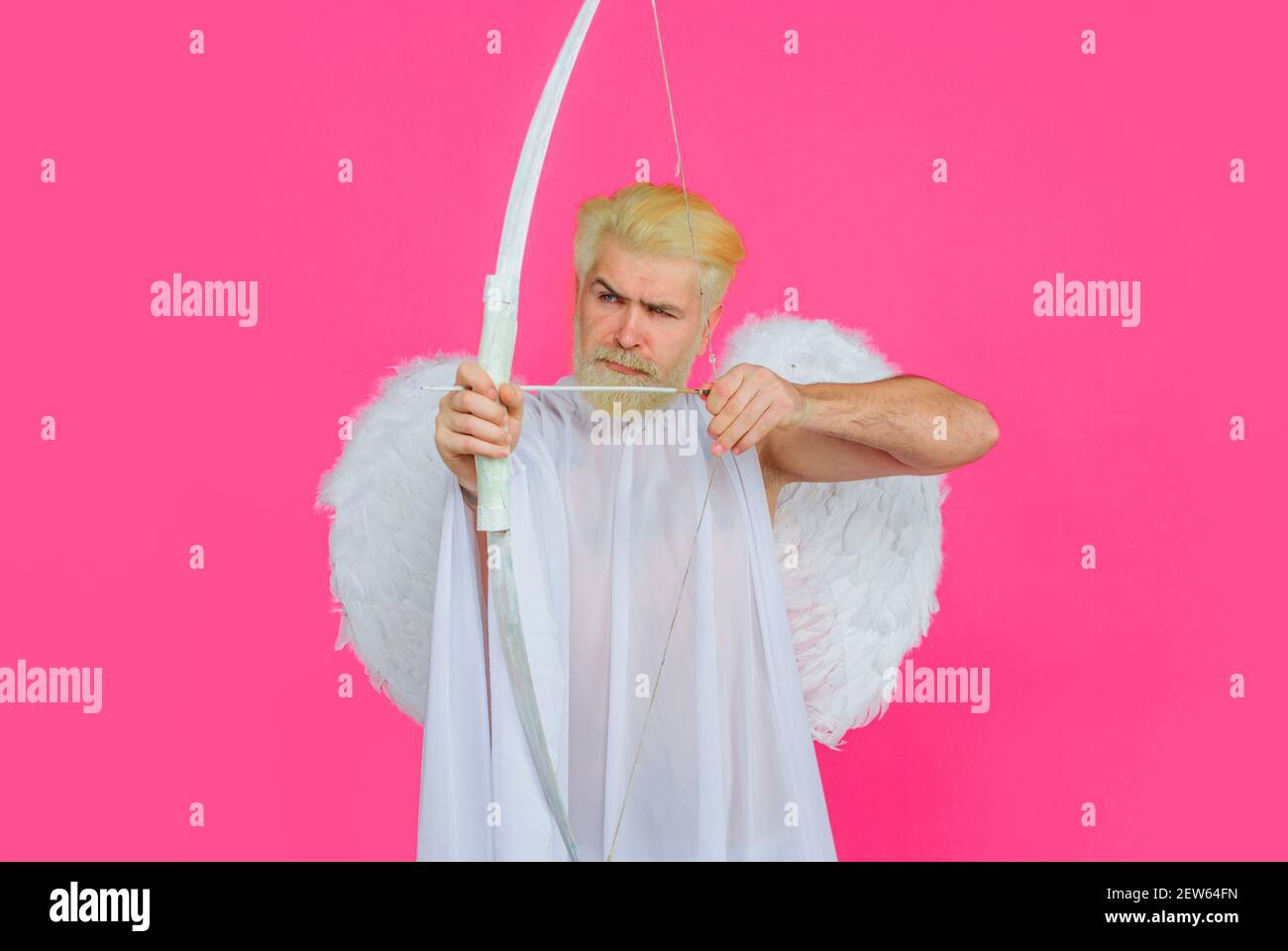 Valentines Day. Bearded angel with bow and arrow. Arrows of love. Cupid in valentine day. Stock Photo