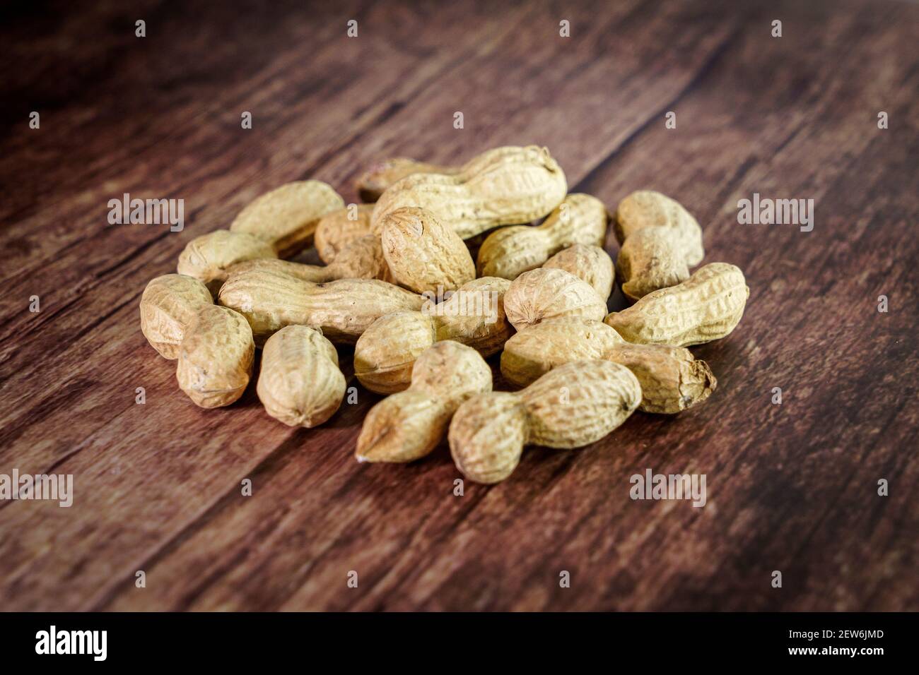 Peanuts on wooden background, composition of nuts, food background. Stock Photo
