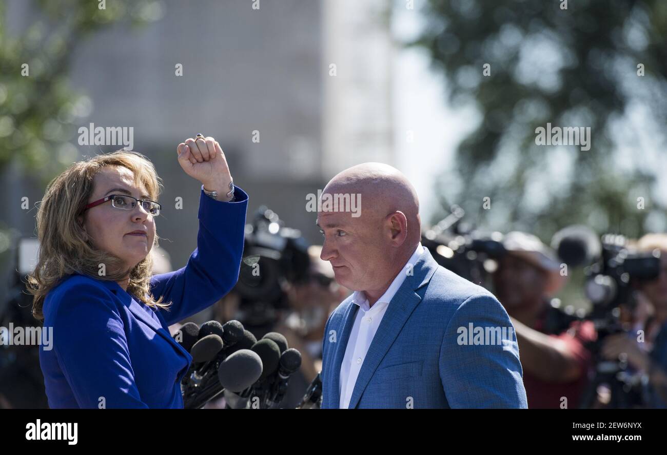 UNITED STATES - OCTOBER 2: Former Congresswoman Gabrielle Giffords, D-Ariz., turns to shake her fist at the Capitol as her husband retired NASA astronaut Captain Mark Kelly looks on during their news conference at the U.S. Capitol on Monday, Oct. 2, 2017, to respond to last nightÕs tragic mass shooting in Las Vegas, NV. They are the Co-Founders of Americans for Responsible Solutions. (Photo By Bill Clark/CQ Roll Call) Stock Photo