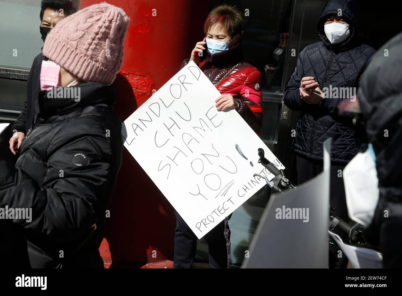 A demonstrator from 318 restaurant workers union holds up a placard during a demonstration against the closure of Jing Fong restaurant in Chinatown. Recent extraordinary rental demands placed by Jonathan Chu, the biggest landlord in Chinatown, on small business has forced many to shutter their doors. Such demands have forced Jing Fong restaurant to end operations by March 7, 2021. Stock Photo