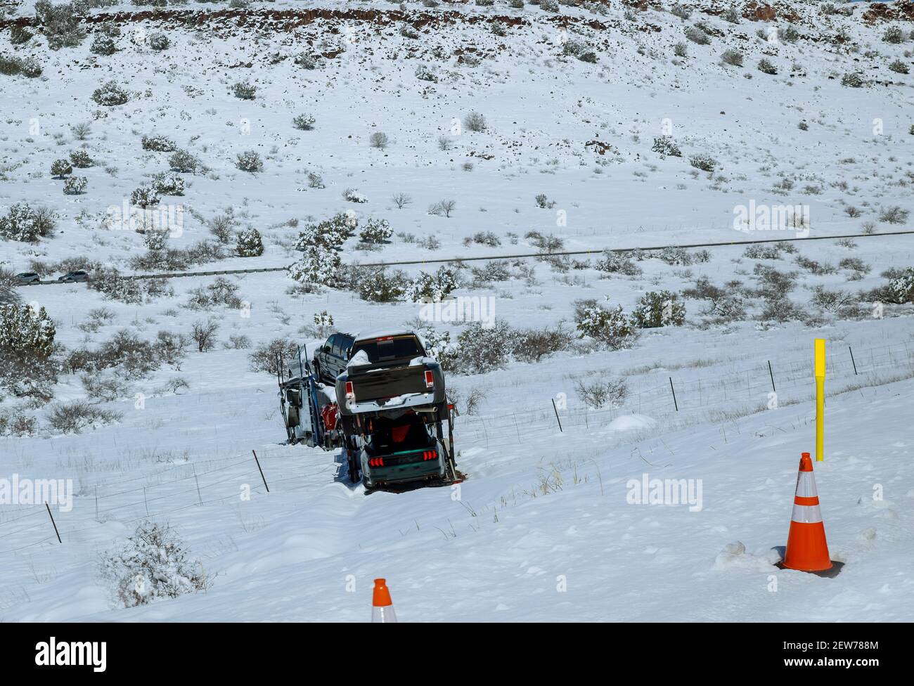 Transportation trailer truck of car on semi-trailer on new cars on the highway hauler accident truck off road through cold weather conditions Stock Photo