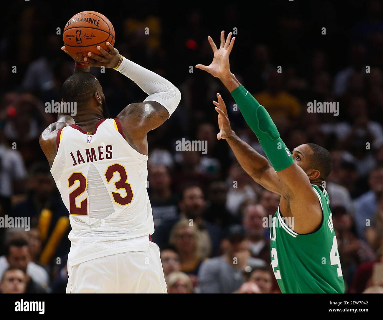 With a ripped jersey, the Cleveland Cavaliers' LeBron James (23) puts up a  shot over the Boston Celtics' Al Horford in the fourth quarter on Tuesday,  Oct. 17, 2017, at Quicken Loans