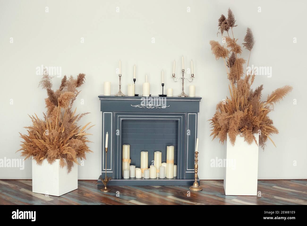 Artificial fireplace decorated with various decorative candles with