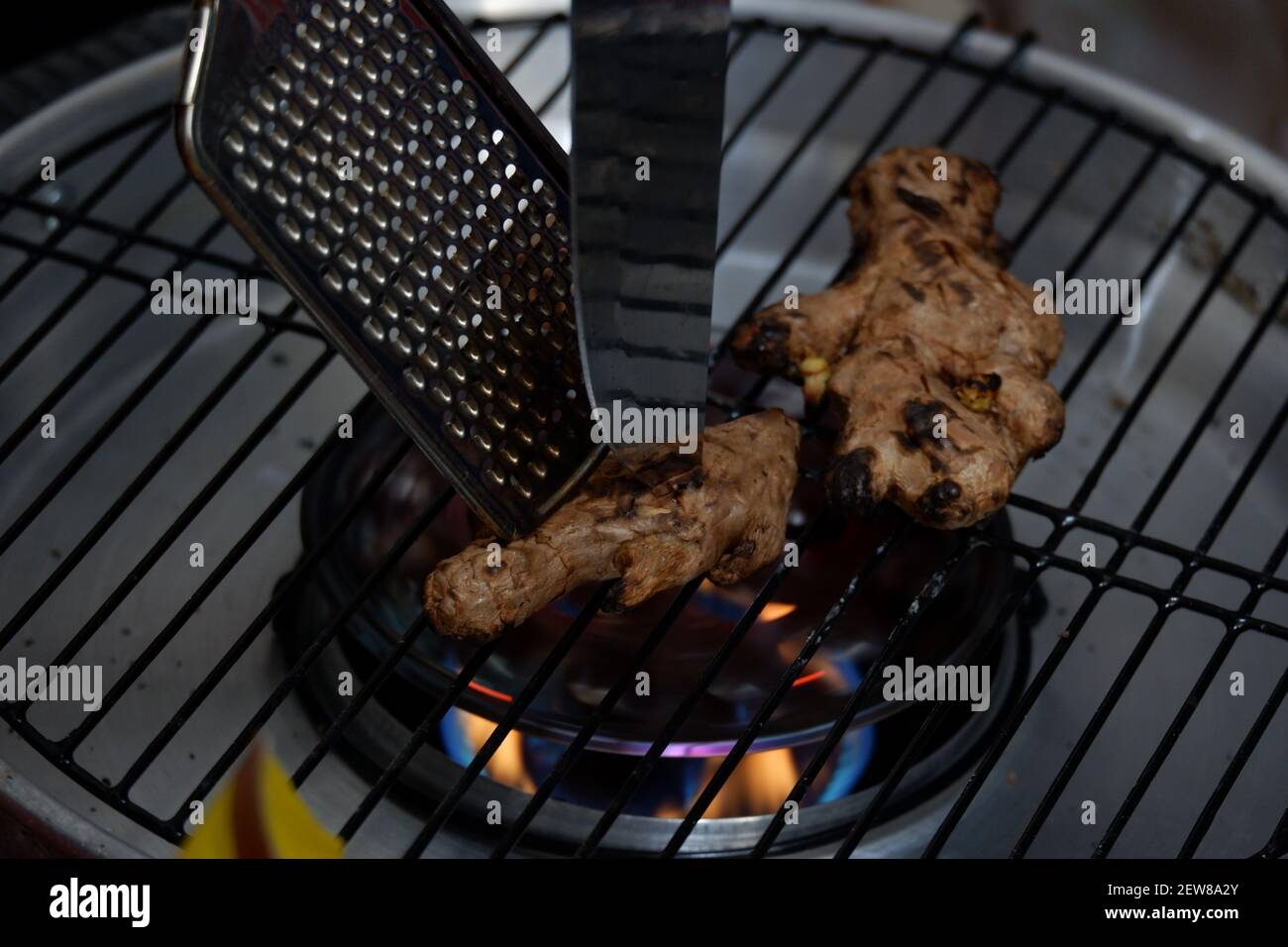 roast the ginger before pounding it using a grill pan on the stove over