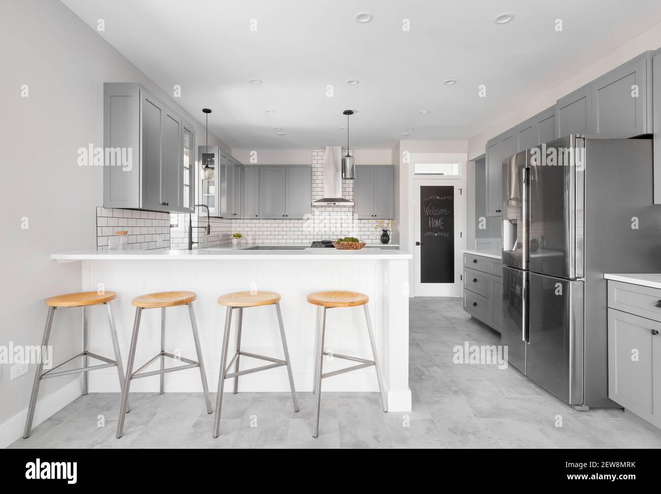 Stainless grey metal kitchen gas stove installed on a the kitchen with a  dark grey table top Stock Photo - Alamy