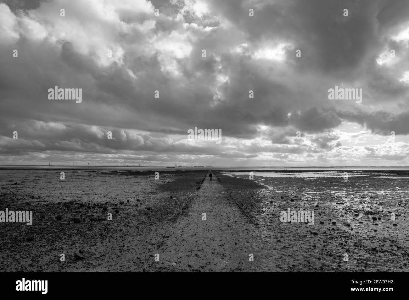 Black and white image of a pathway going out into the sea at Westcliff, Essex, England Stock Photo