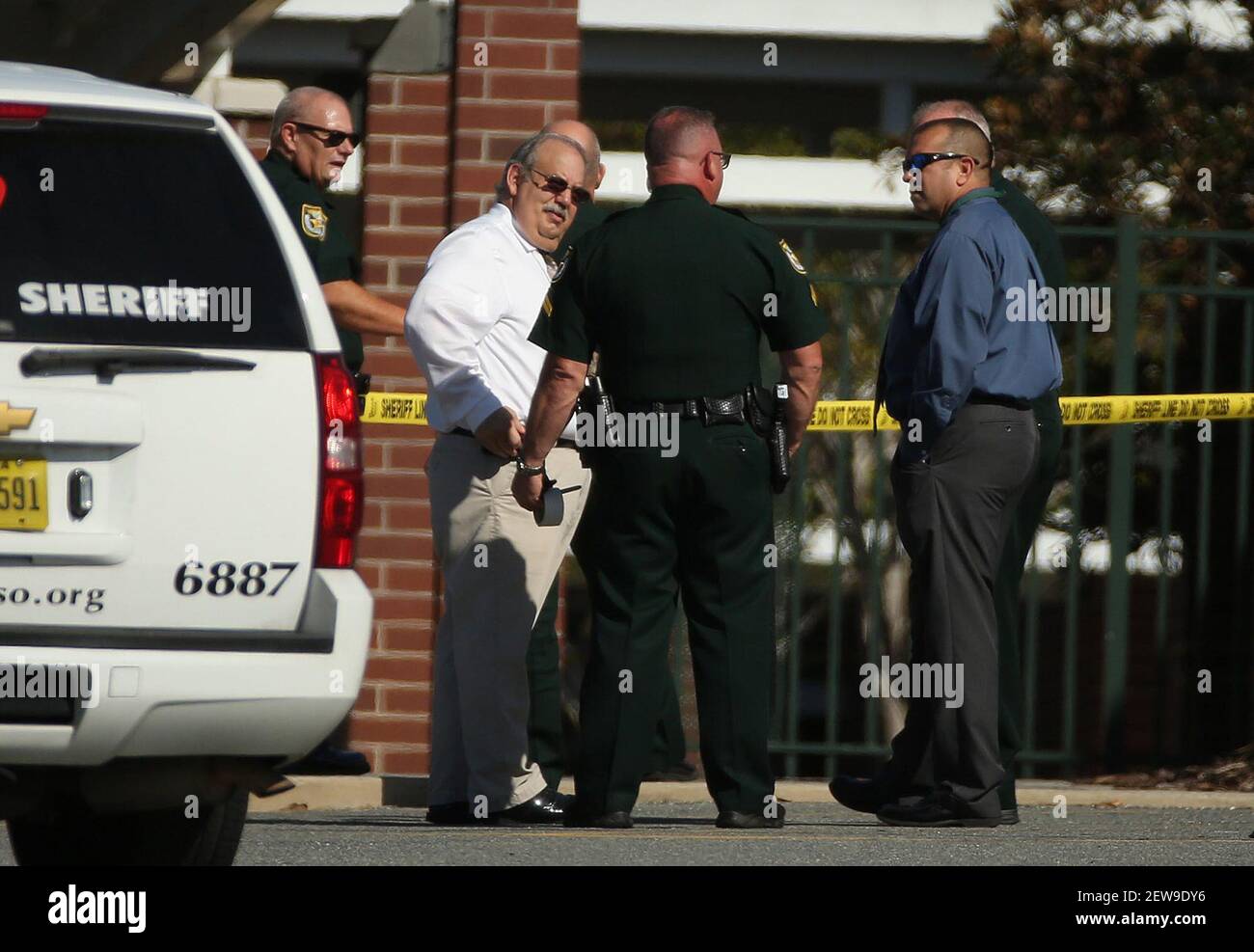 Law enforcement officers investigate the scene where a Lake Minneola