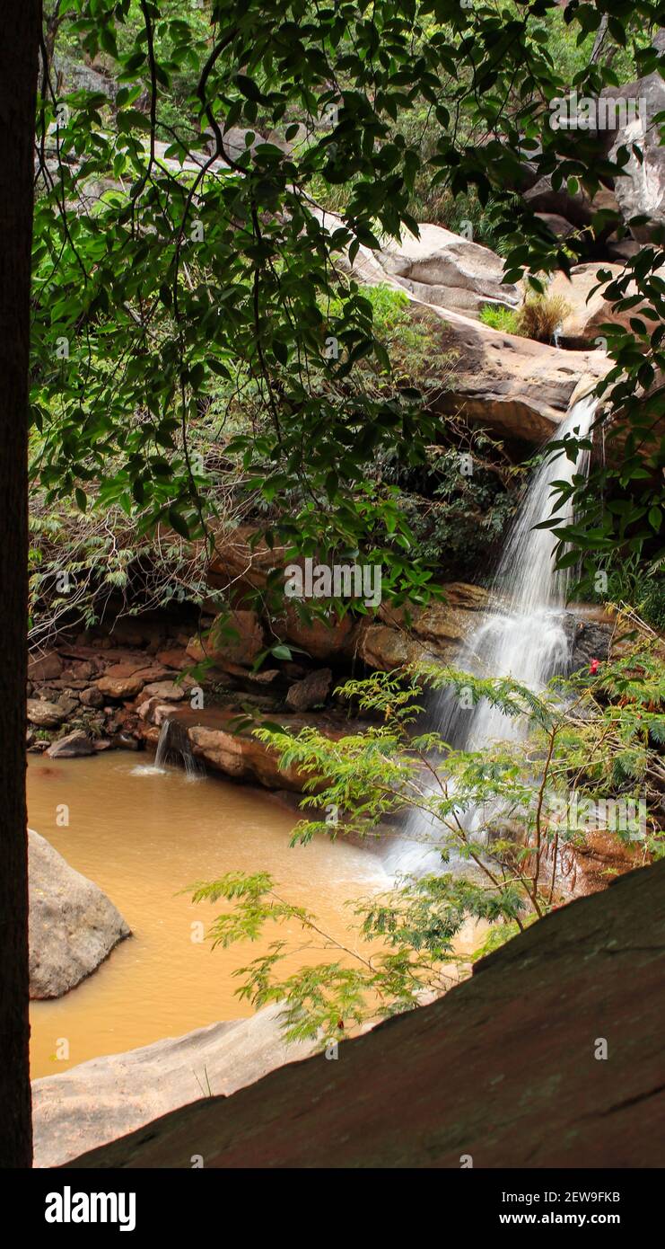 A vertical shot of a small waterfall during the daytime Stock Photo - Alamy