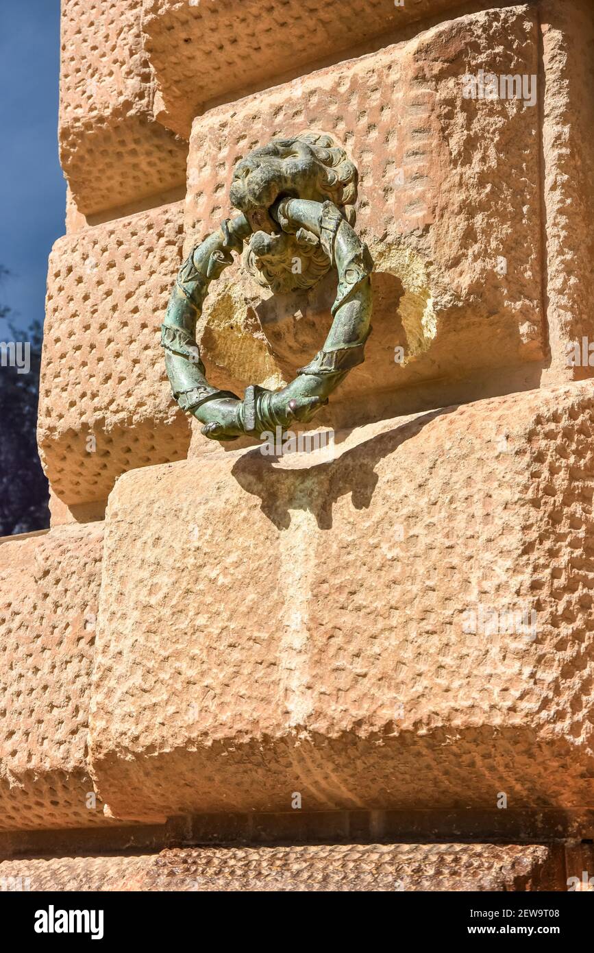 Bronze Lions Head on stone wall at the Palace of Alhambra Stock Photo