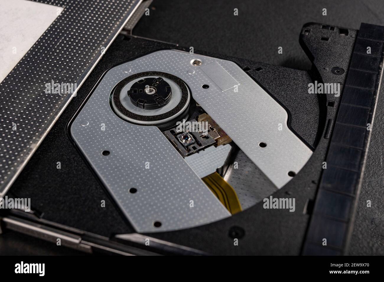 The inside of the CD reader. A laser mechanism for reading compact discs. Dark background. Stock Photo