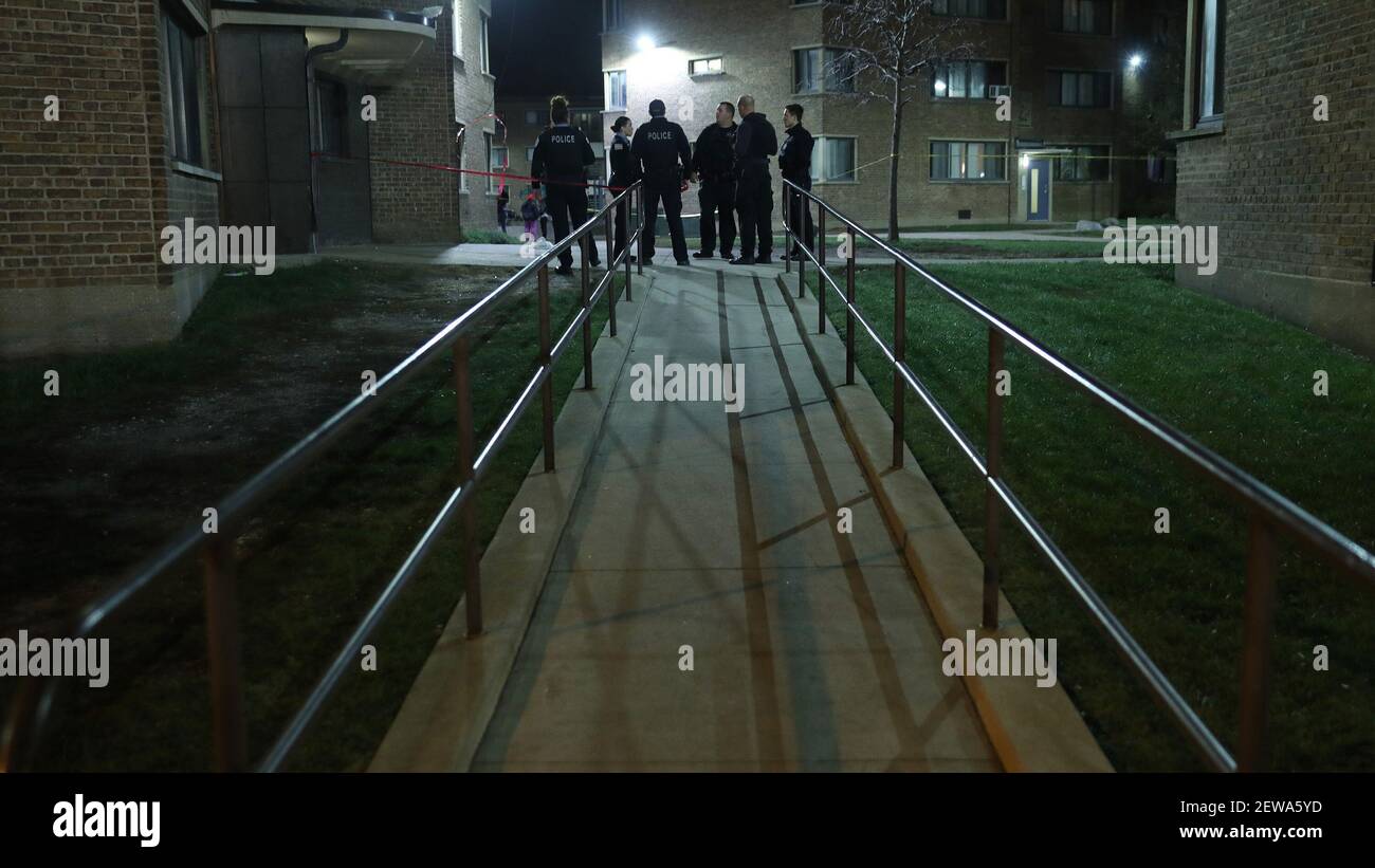 Police officers guard the scene of a shooting in the west end of the