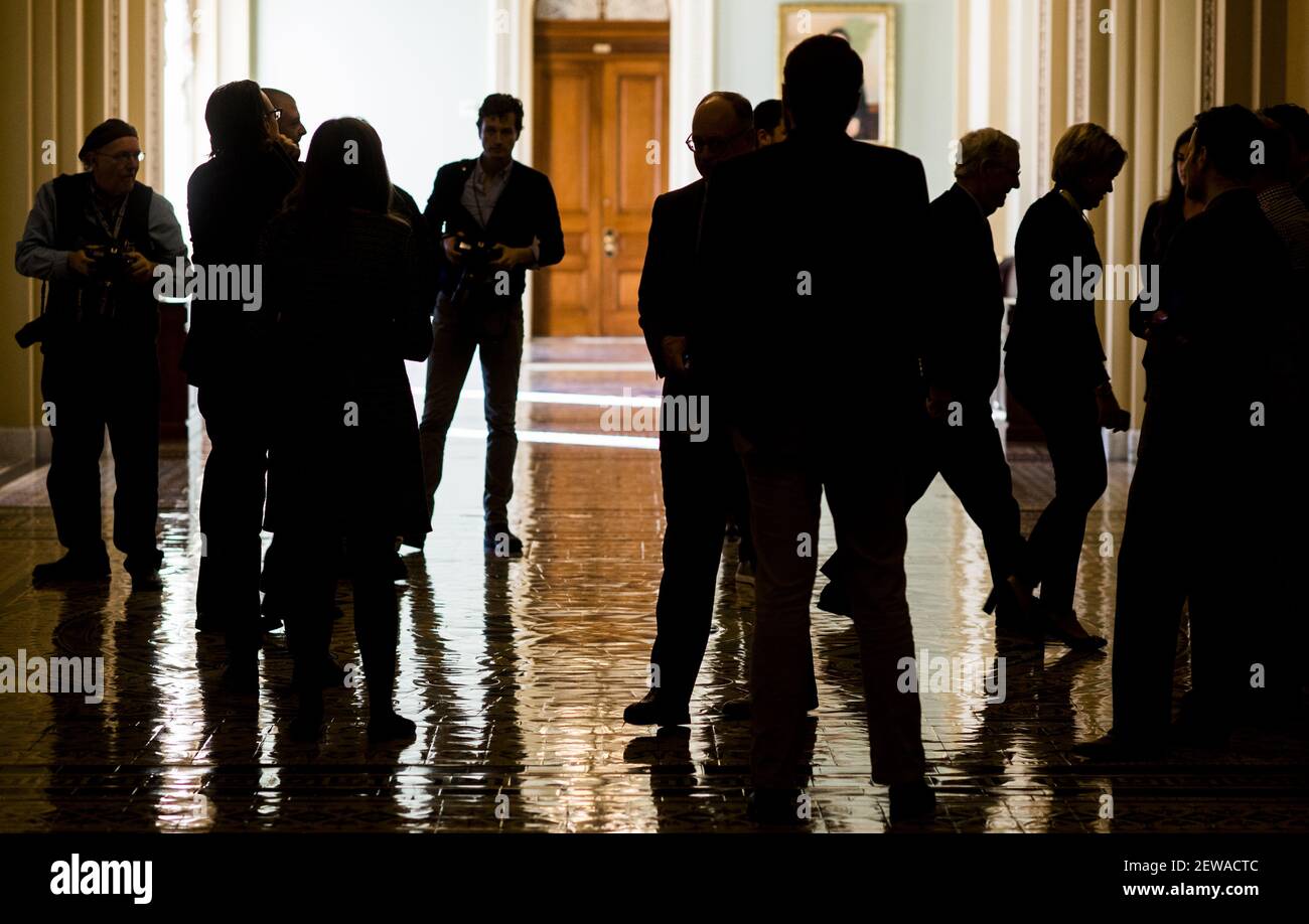 UNITED STATES - DECEMBER 1: Senate Majority Leader Mitch McConnell, R-Ky., right, walks through a crowd of reporters and photographers on his way to the Senate floor for a procedural vote on tax reform in the Capitol on Friday, Dec. 1, 2017. (Photo By Bill Clark/CQ Roll Call) Stock Photo