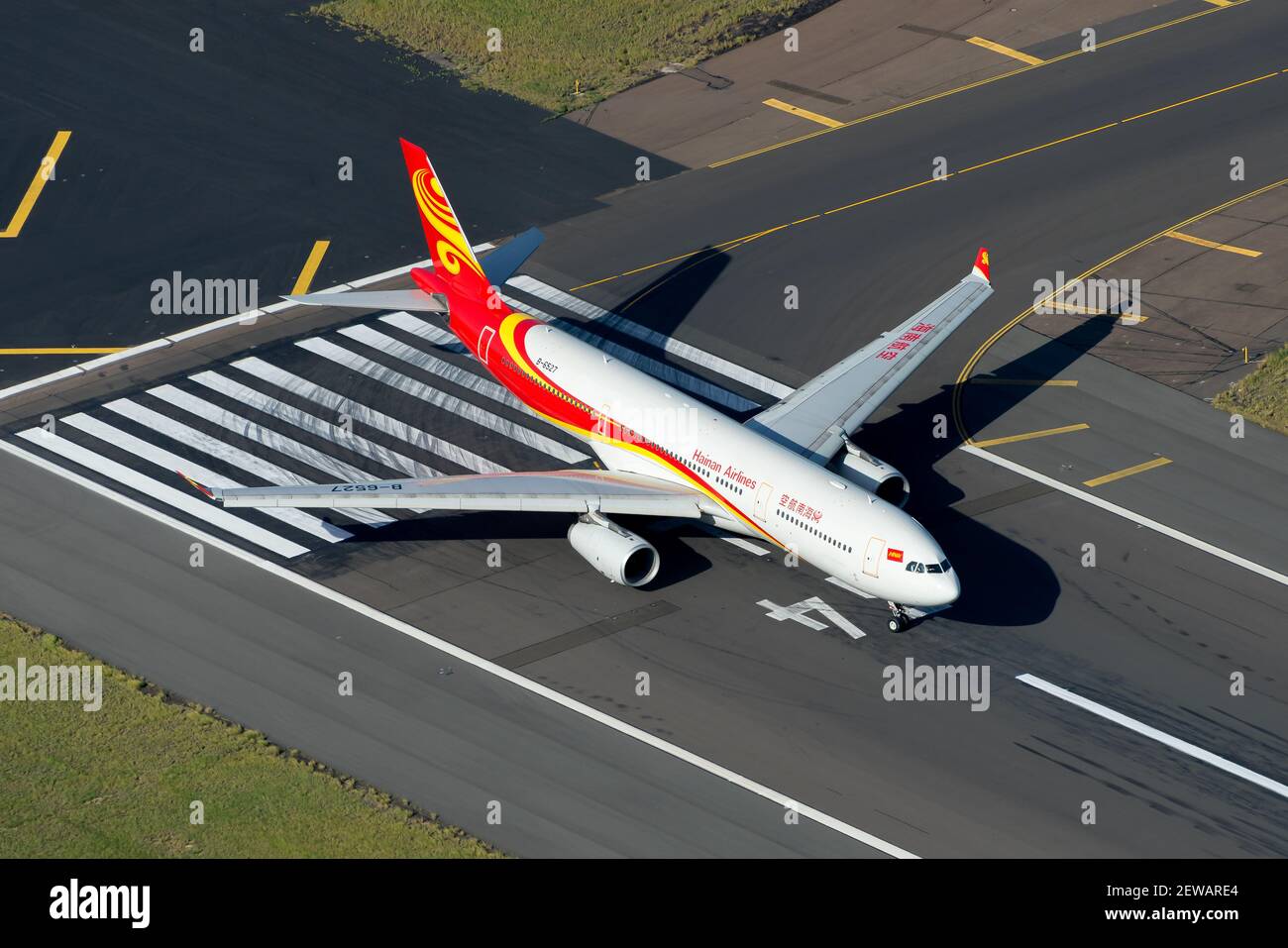 Hainan Airlines Airbus A330 aircraft seen from above at international airport runway. Aerial view of Airbus A330-300 airplane B-6527 of Hainan Airline. Stock Photo