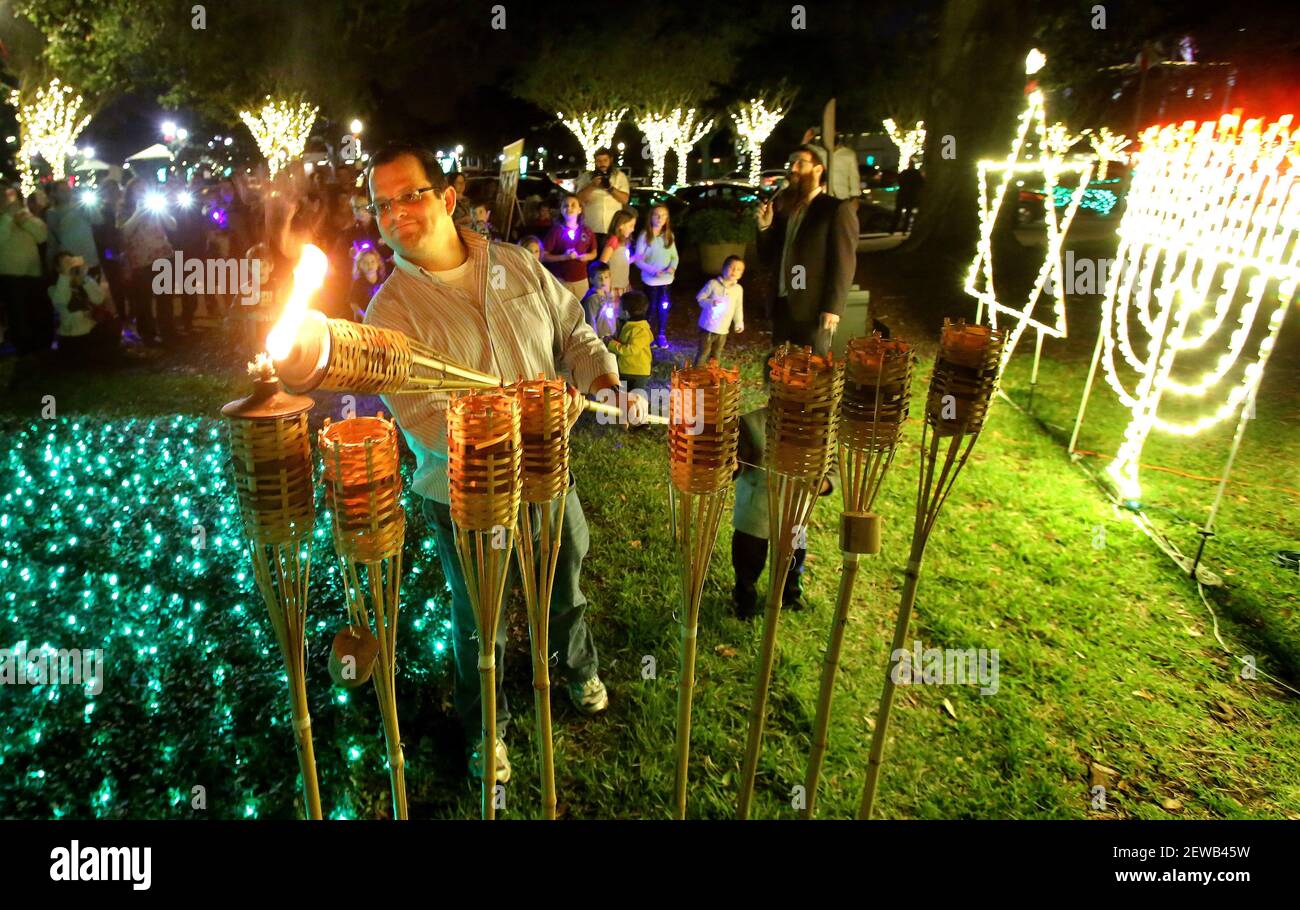 Adam Rashkind of Winter Garden, Fla. symbolically lights the first candle of the eight days of Hannukah as members of the central Florida Jewish community and residents of Winter Garden gather for the Menorah lighting ceremony on Tuesday, December 12, 2017. The lighting was hosted by the Chabad of South Orlando. (Photo by Joe Burbank/Orlando Sentinel/TNS/Sipa USA) Stock Photo