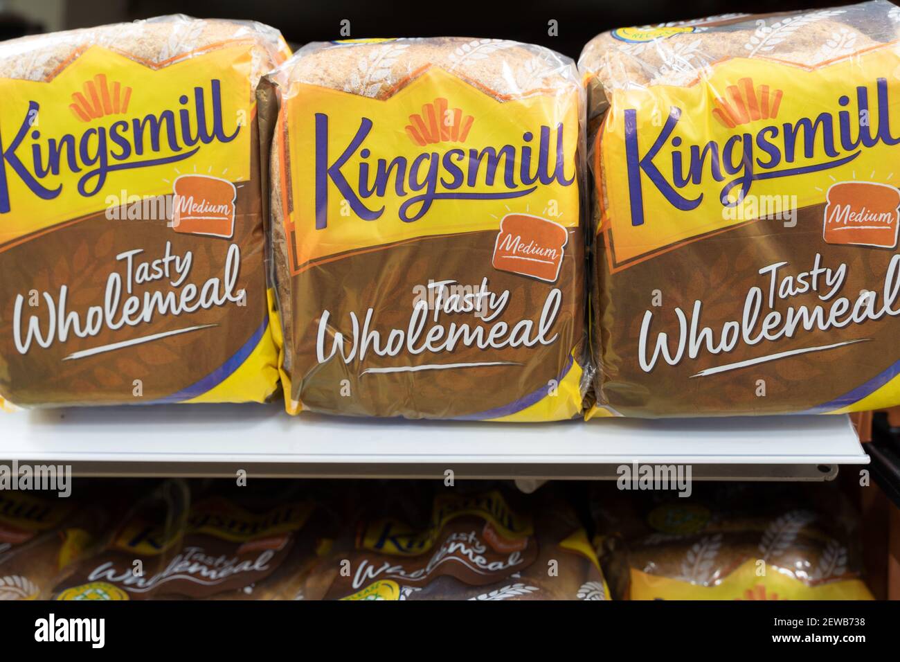 three loaves of sliced bread for toast and sandwiches on shelves for