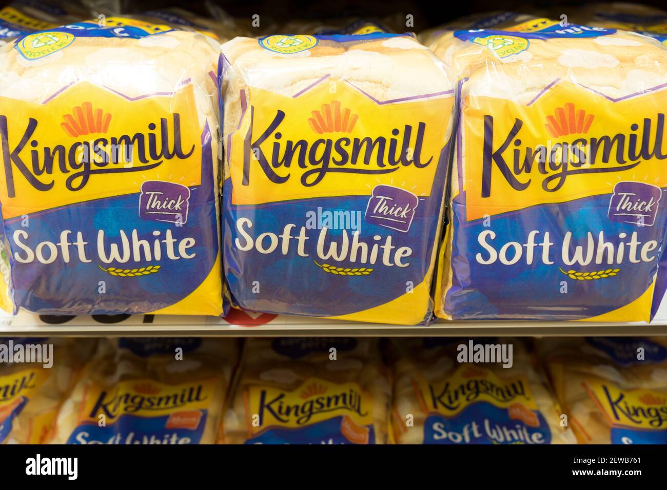three loaves of sliced bread for toast and sandwiches on shelves for