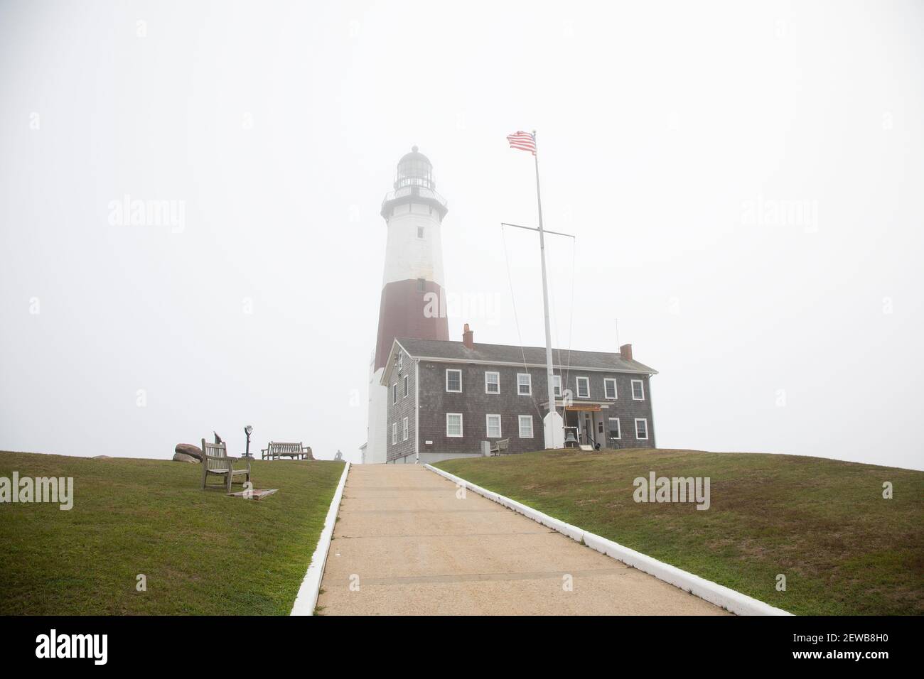 A cloudy day view of the Montauk Point Lighthouse covered with fog in