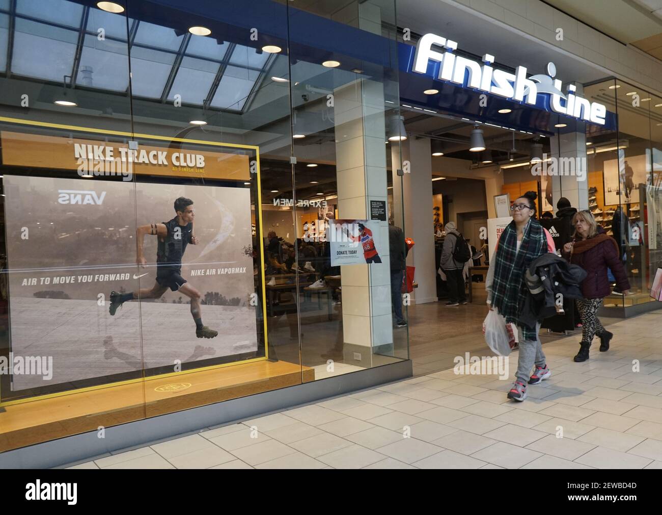 Shoppers pass the Finish Line store in the Queens Center Mall in the  borough of Queens in New York on Sunday, December 17, 2017, a week before  Christmas. Retailers are reporting a