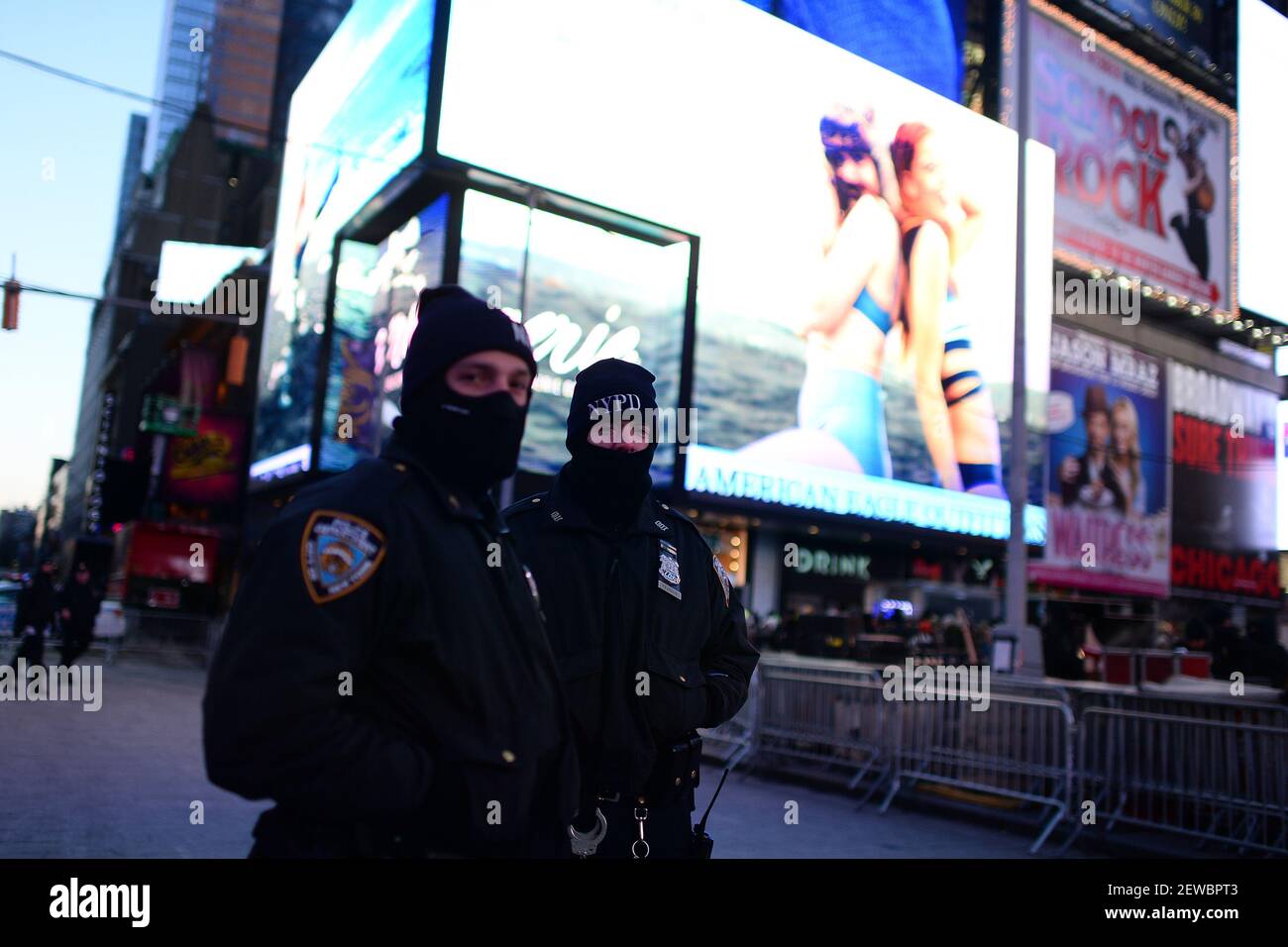 Two NYPD officers stand in Times Square during one of the coldest New ...