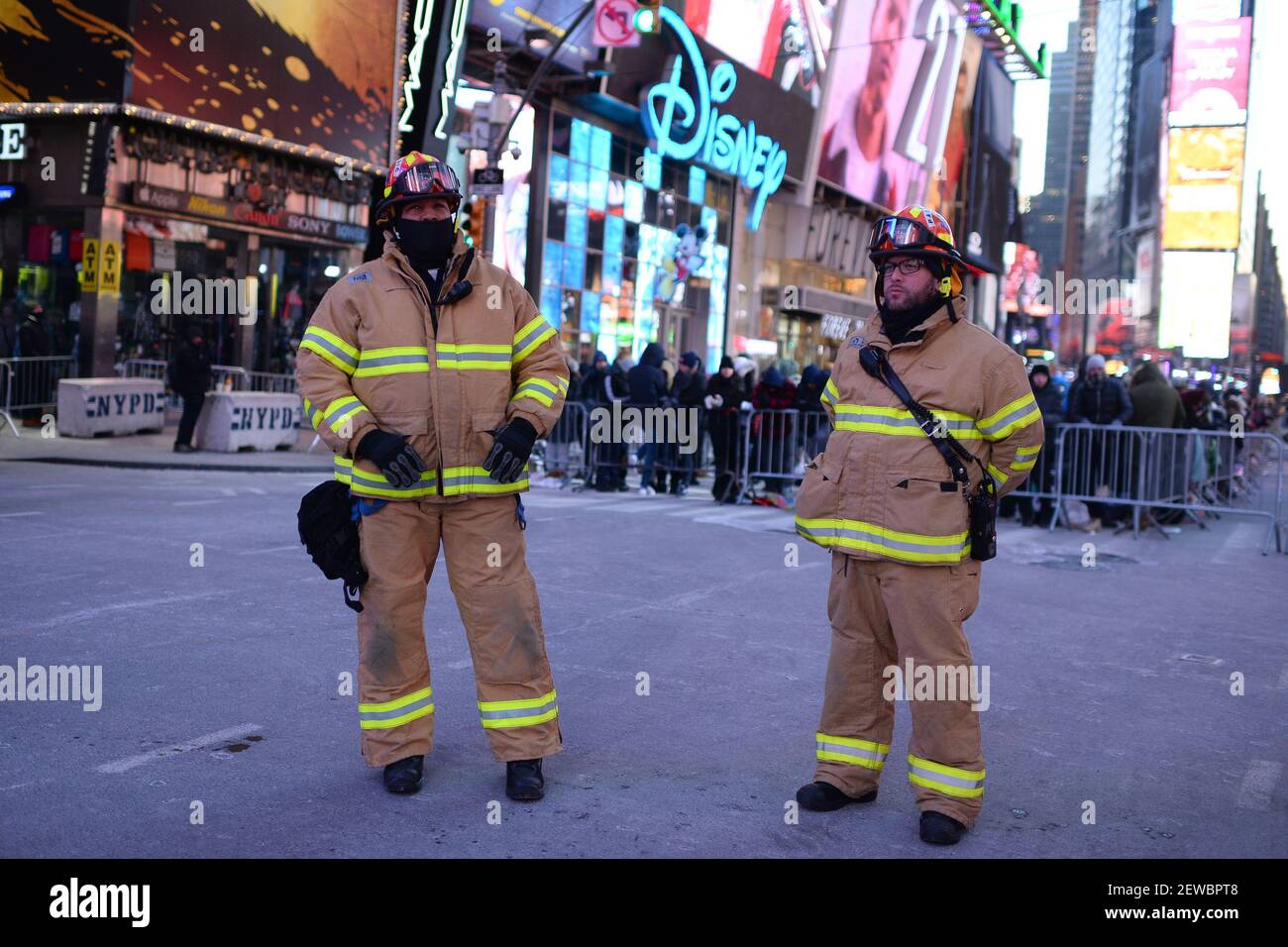 Two FDNY fireman stand in Times Square during one of the coldest New
