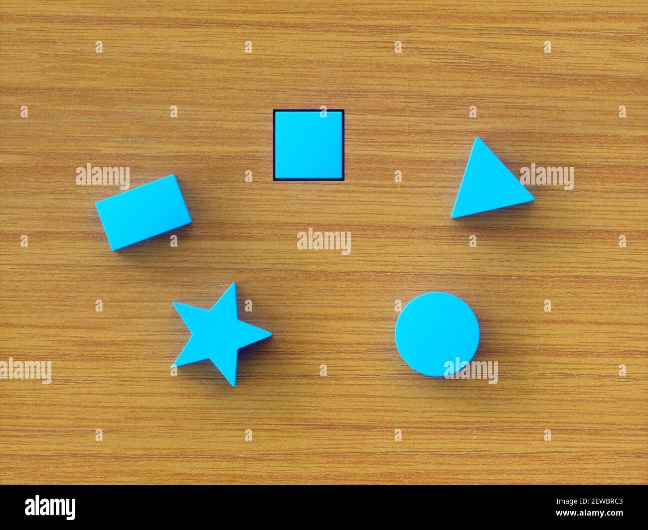 Assorted blue building blocks on wooden table. Concept image of educational toy and psychological test. Stock Photo