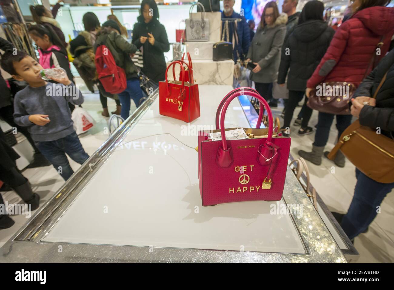 Tourists throng the Michael Kors display at Macy's Herald Square flagship  store in New York on the day after Thanksgiving, Black Friday, November 24,  2017. The tally of foreign visitors to the