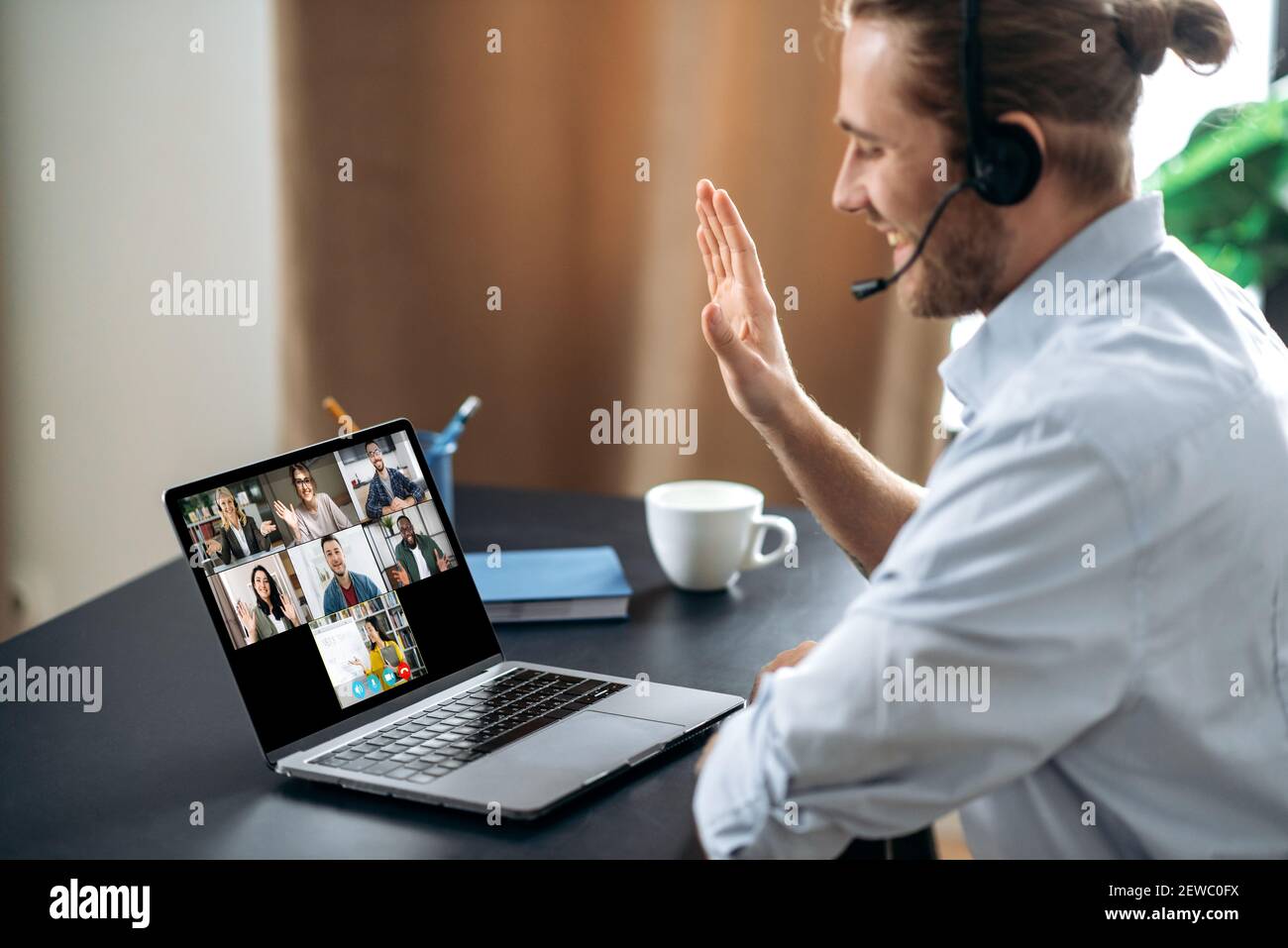 Group brainstorm, online video meeting, virtual conference with multiracial colleagues. Caucasian man communicate with business partners by video call uses laptop and app, work from home Stock Photo