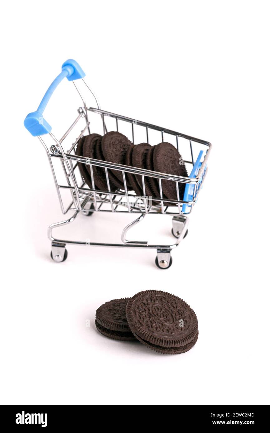 Chocolate cookie and shopping cart. Isolated on a white background Stock Photo