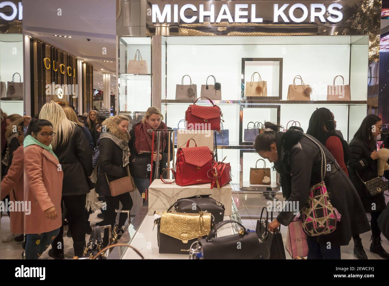 Hordes of shoppers throng the Michael Kors display at Macy's Herald Square  flagship store in New York on the day after Thanksgiving, Black Friday,  November 24, 2017. Michael Kors Holdings Ltd. announced
