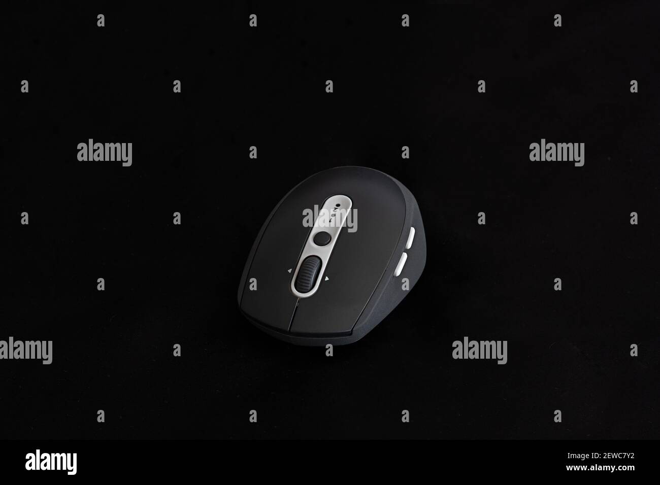 Black wireless mouse on black background Stock Photo