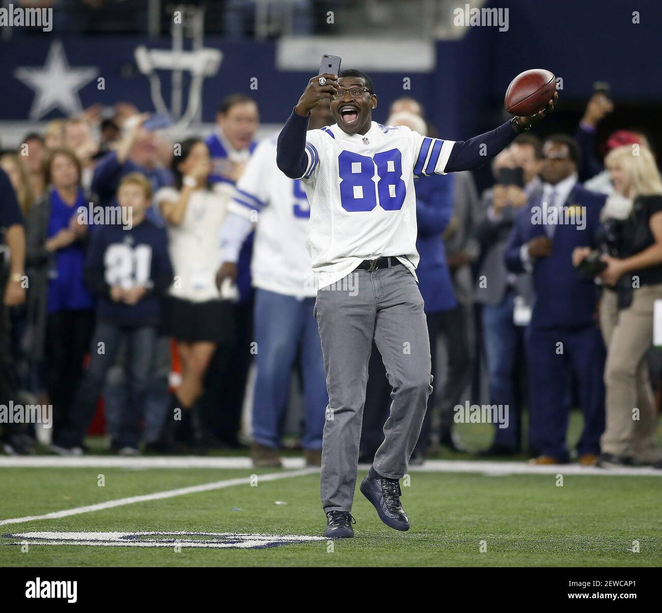 Former Dallas Cowboys receiver Michael Irvin (88) takes a selfie as he was  one of several players introduced from the 1992 Super Bowl team before a  game against the Philadelphia Eagles on