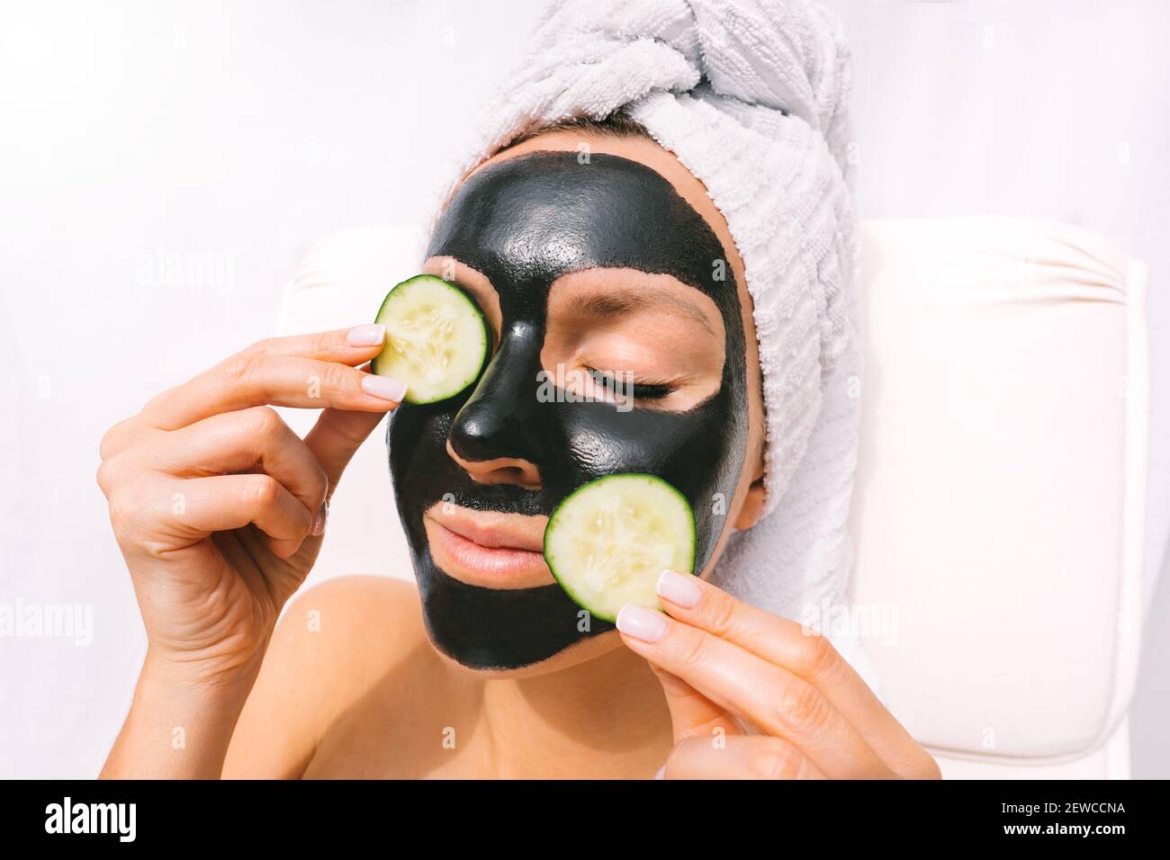 Woman with charcoal facial mask. Face skin care. Beauty treatments. Spa therapy Stock Photo
