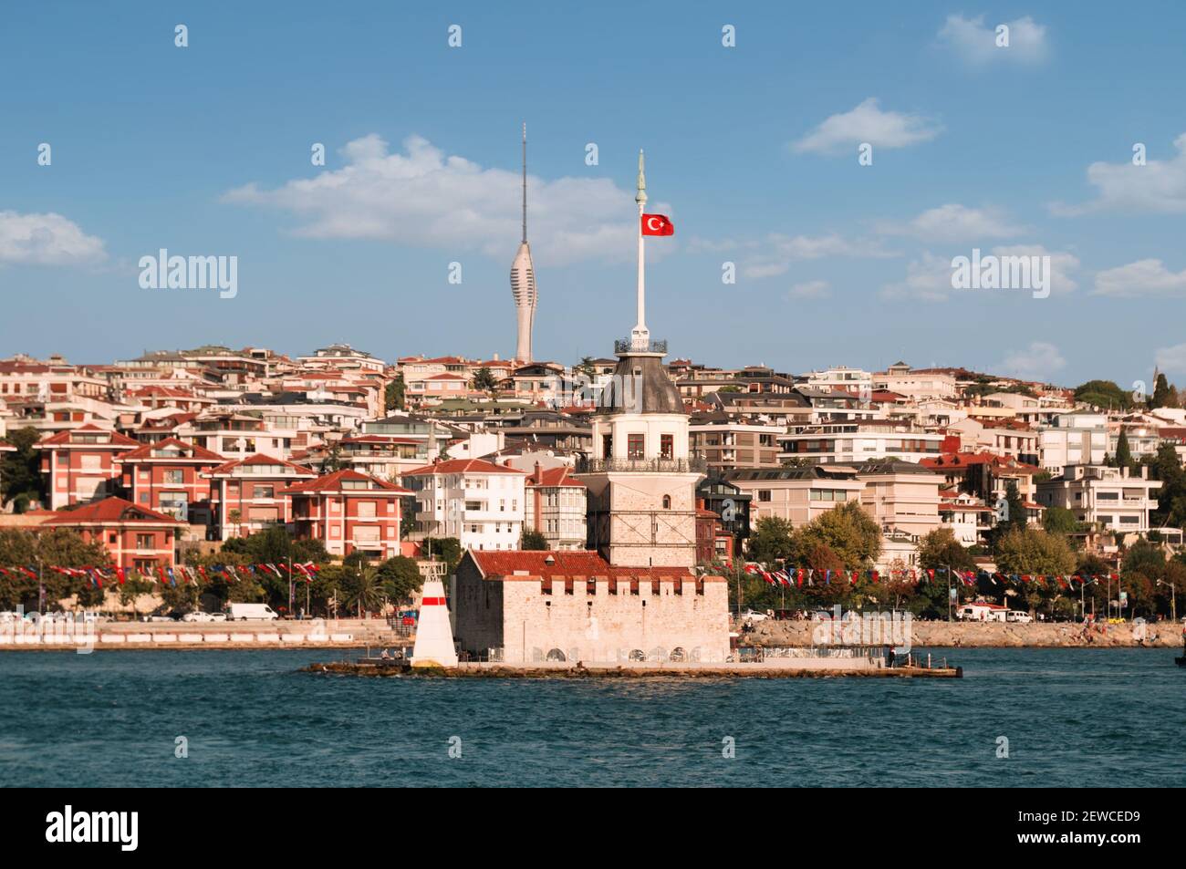 View from the waters of Bosporus Strait on residential blocks of Uskudar neighborhood with legendary Maiden's Tower spire competing with Istanbul TV Stock Photo