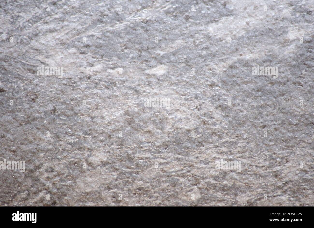 A fragment of a natural gray stone of rough processing. Background ...