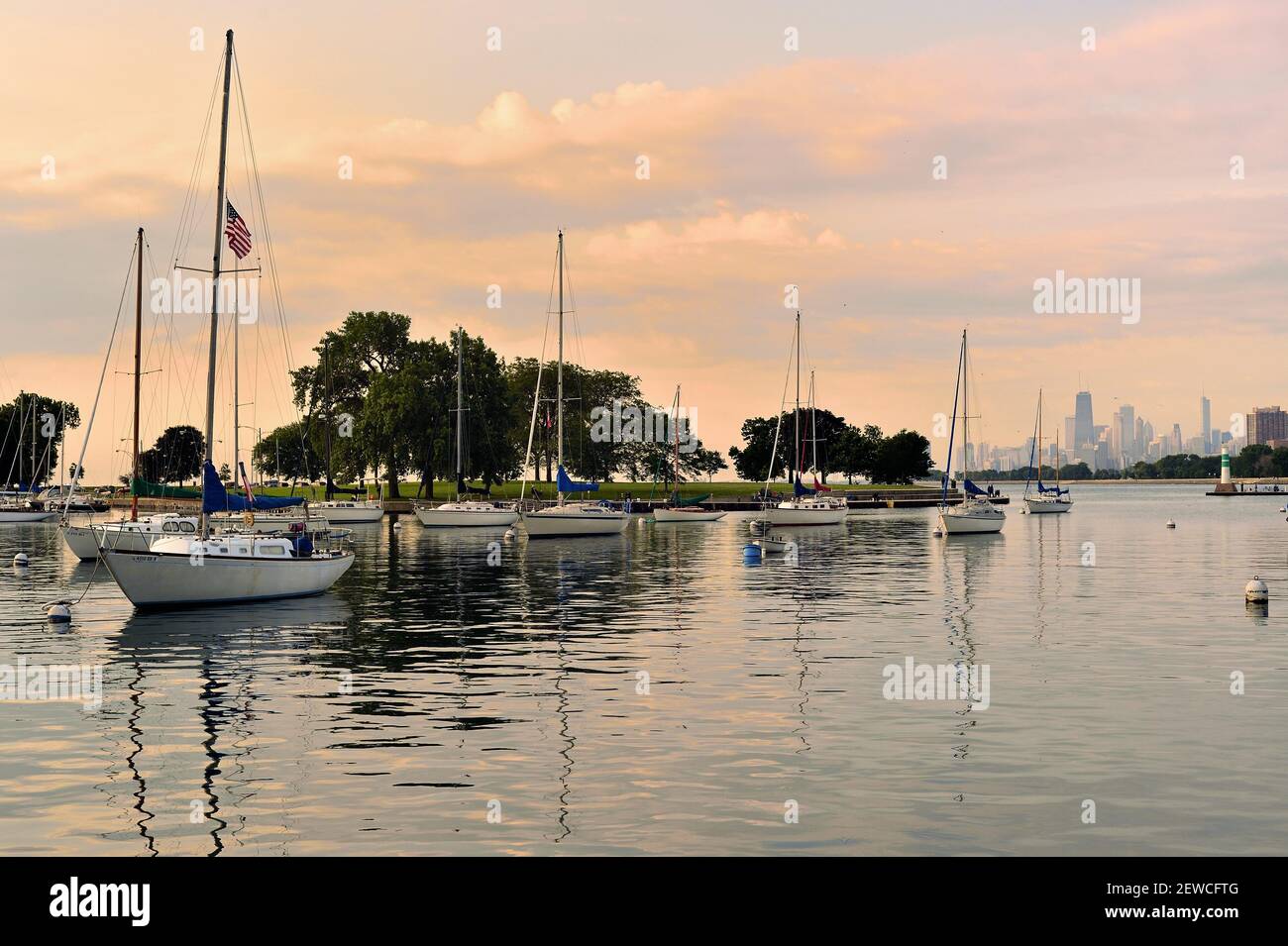 Chicago, Illinois, USA. Sailboats and pleasure craft rest within Chicago's Montrose Harbor shortly after sunrise on the Fourth of July. Stock Photo