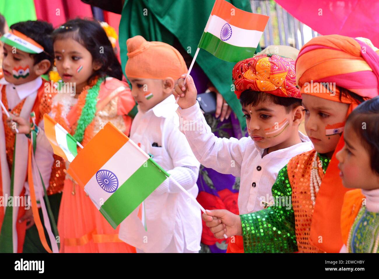 Indian children paint the tricolor of Indian flag on their face and ...
