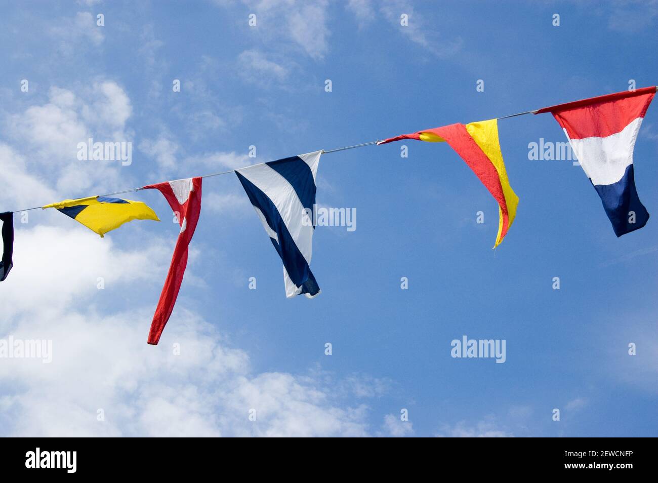 Naval signal flags fluttering in the sunshine Stock Photo - Alamy