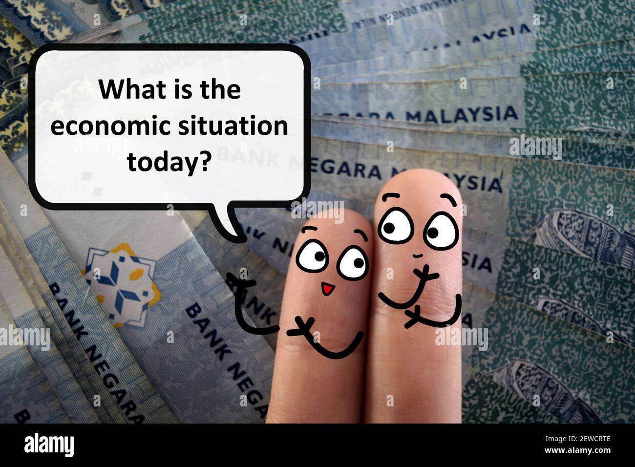 Two fingers are decorated as two person. One of them is asking another what is the economic situation today. Stock Photo